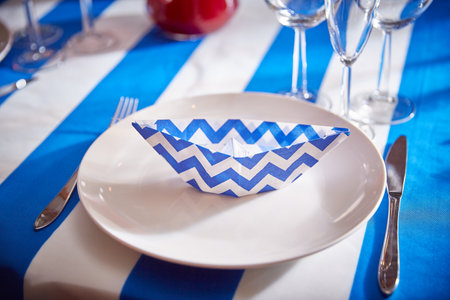 festive plate with a folded napkin. Decor for celebrating the holidayの写真素材