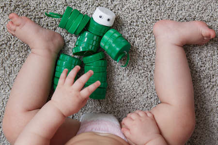 reuse of materials. A child plays a robot toy made of plastic pet bottle capsの写真素材