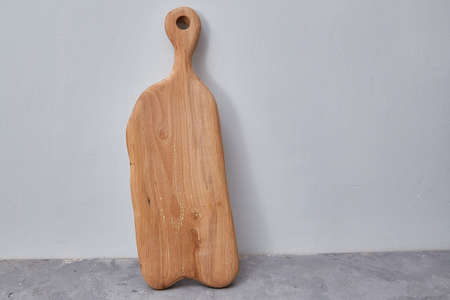 cutting board stands vertically near a solid wall.の写真素材