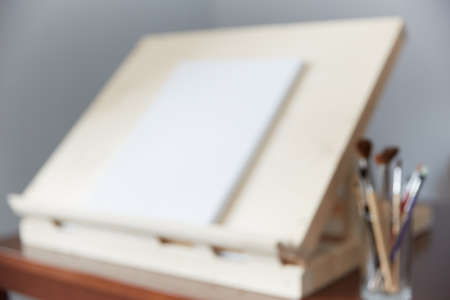 easel is out of focus. background for a text on teaching drawing in an art studio or workshop.