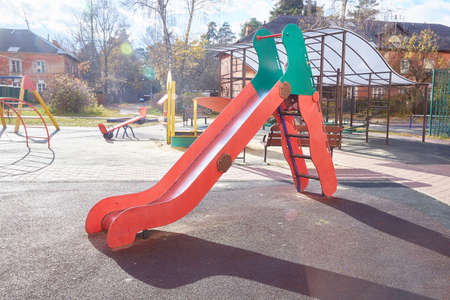 empty slide on the playground on an autumn sunny day.