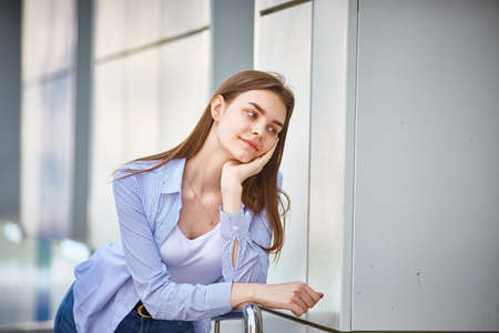 Dreaming teen girl close-up. Looks away and thinks about a good futureの写真素材