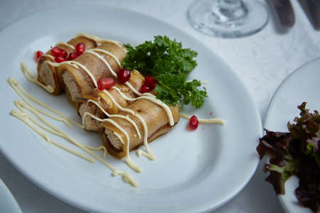Eggplant rolls with cheese on a plate in a restaurant.の写真素材