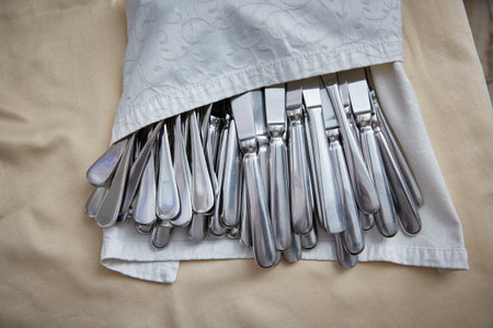 Top view of the cutlery in a restaurant at a wedding or a festive event.の写真素材