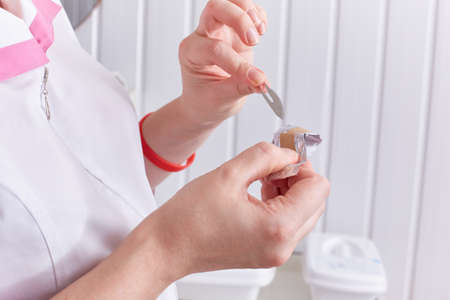doctor pulls out the blade to take the scrape.