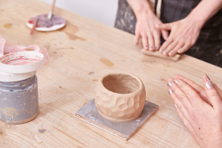 Womens hands are molded from clay The handle of a cupの写真素材