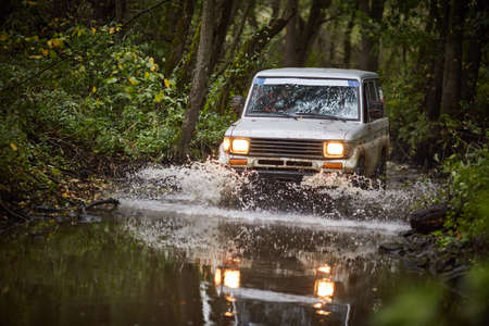 Moscow region, Russia - 28.09.2018. Off-road travel. a Toyota truck is driving along a streamのeditorial素材