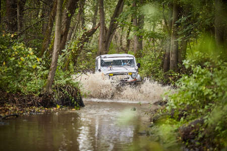 Moscow region, Russia - 28.09.2018. Traveling off-road on a UAZ truck. The car is driving along the streamのeditorial素材
