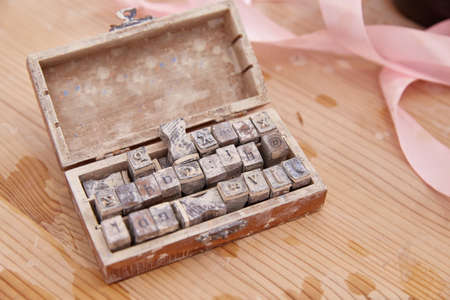 latin letter stamps in a box. lifestyle.