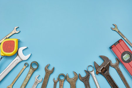 A set of wrenches and working tools on a blue background with a copy space. Labor day.の写真素材