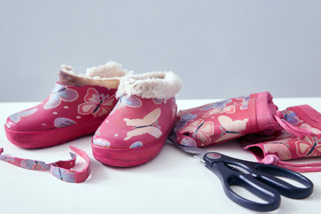 Recycling. Making galoshes from torn childrens boots. Recycling of old things. A second life for old things. Step 2の写真素材