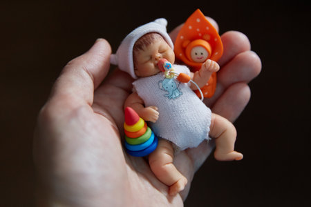 A baby doll in the palm of your hand. A miniature. Children for dolls.の写真素材