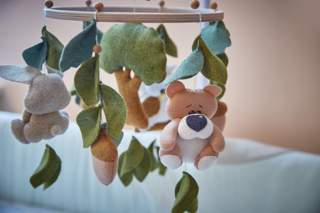 Childrens toy carousel over a babys crib. Close-up.の写真素材