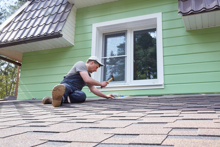 A worker greases the roof of the terrace with mastic.の写真素材