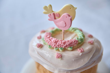 Captivating, springtime elegance radiates from this beautiful bird-topper cake, a whimsical dessert perfect for celebrations, baby showers, or a gentle touch of delight, conveying peaceful emotions.の写真素材