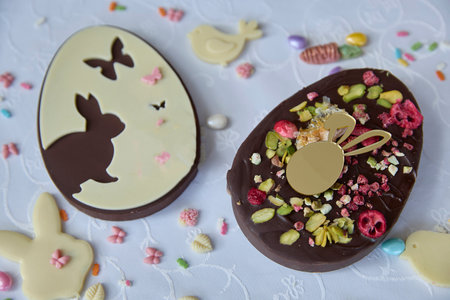 Delightful chocolate easter eggs gleam, promising sweet celebrations, springtime gatherings, and heartfelt wishes, evoking warm, joyful emotions.の写真素材