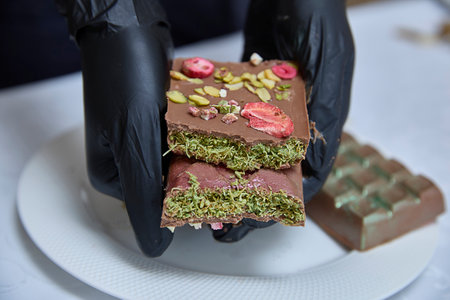 Dubai chocolate. Delicious artistry, delicately displayed, promises a moment of luxurious indulgence, perfect for promoting artisan chocolates, bakeries, or dessert menus.の写真素材