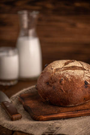 Freshly baked rye bread on a wooden cutting board. Selective focus.の写真素材