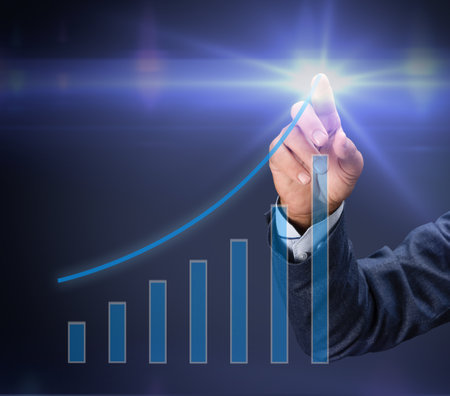 Businessman drawing a virtual graph illustrating upward trends in business growth and success, representing financial achievements and strategic planning in a digital environmentの写真素材