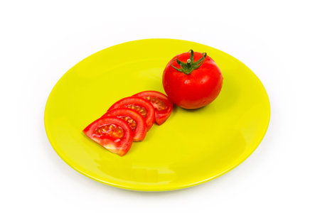 Tomato on green plateの写真素材