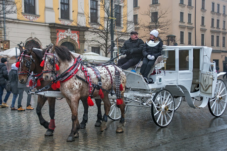 POLAND, KRAKOW - JANUARY 01, 2015: Horse carriages in oldtown in a first day of New Year 2015. Krakow is the second largest and one of the oldest cities in Poland.のeditorial素材