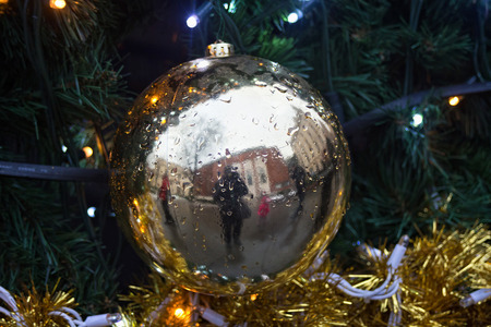 POLAND, KRAKOW - JANUARY 01, 2015: Selfie of photographer in the Christmas tree toys with reflection of historical buildings of old Krakow.のeditorial素材