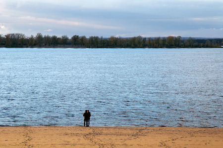 SAMARA, RUSSIA - OCTOBER 12, 2016: Unknown man and woman on an autumn evening on the coast of the Volga River in Samara.The city is situated on the east bank of the Volga.のeditorial素材
