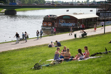 KRAKOW, POLAND - MAY 27, 2016: People resting on a warm spring day on the banks of the Vistula River in the center of Krakow, near the Wawel Castle.のeditorial素材