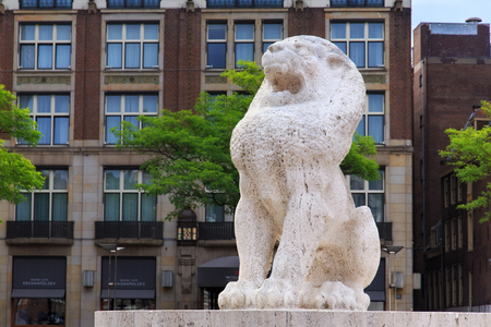 AMSTERDAM, NETHERLANDS - JUNE 25, 2017: Stone lion as part of The National Monument (architect J.J.P. Oud) on Dam Square in center of Amsterdam. Is a 1956 World War II monument in the Netherlands.のeditorial素材