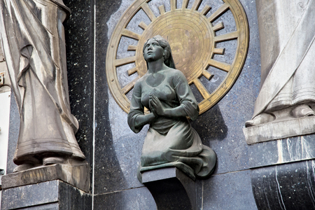 AMSTERDAM, NETHERLANDS - JUNE 25, 2017: Sculpture on the wall of a one of the historic building on Damrak Street. On the street there are cultural centers, many cafes, craft workshops and museums.のeditorial素材