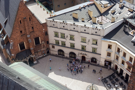 KRAKOW, POLAND - MAY 29, 2016: Tourist group of people near the St. Mary's Basilica, waiting for the time when the trumpeter from the tower of the church will perform the Polish anthem known as Hejnalのeditorial素材