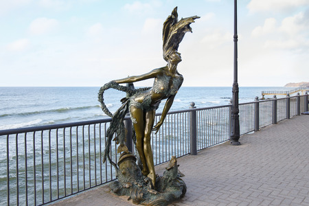 SVETLOGORSK, RUSSIA - APRIL 23, 2017: Sculpture of a mermaid Undine on the Svetlogorsk Promenade with Baltic Sea on the background. The sculpture is a popular tourist attraction in town.のeditorial素材