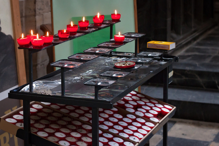 LEUVEN, BELGIUM - SEPTEMBER 05, 2014: Traditional red candles in the St. Peter's Church of Leuven.のeditorial素材