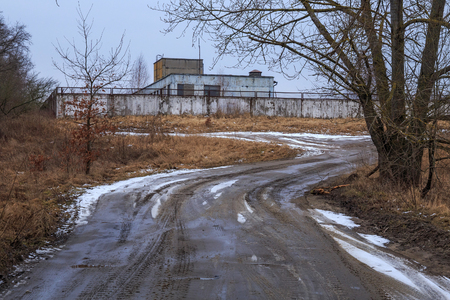 Early spring rural landscape with road and old abandoned building.のeditorial素材