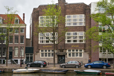AMSTERDAM, NETHERLANDS - JUNE 25, 2017: Old building of the Van Noortschool on Prinsengracht street near the one of the water canals in the historical part of Amsterdam.のeditorial素材