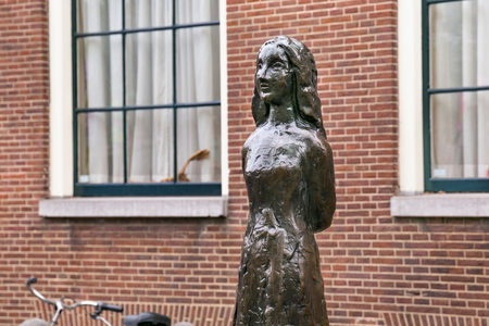 AMSTERDAM, NETHERLANDS - JUNE 25, 2017: Anne Frank statue on Westerkerk Plaza near the Anne Frank House. Anne Frank was a German-born diarist. One of the most discussed Jewish victims of the Holocaustのeditorial素材