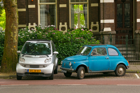 AMSTERDAM, NETHERLANDS - JUNE 25, 2017: Two small passenger cars on one of the streets in the center of Amsterdam.のeditorial素材