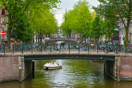 AMSTERDAM, NETHERLANDS - JUNE 25, 2017: Old bridges on the one of the water canals in the historical part of Amsterdam.のeditorial素材