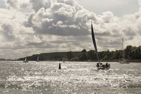 KLAIPEDA, LITHUANIA - SEPTEMBER 22, 2018: Small yachts are sailing in the waters of the Curonian Lagoon near the port of Klaipeda (former town name is Memel).のeditorial素材