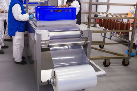 Process of the smoked sausages packaging in the meat plant.の写真素材