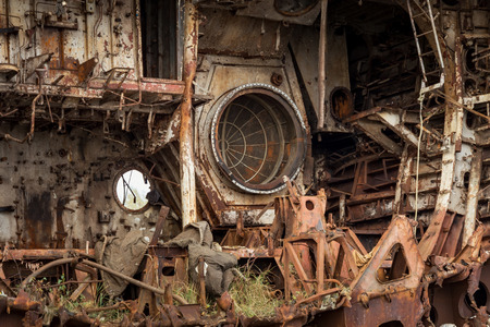 Internal parts of decommissioned marine ship that was cut and left on the shore.