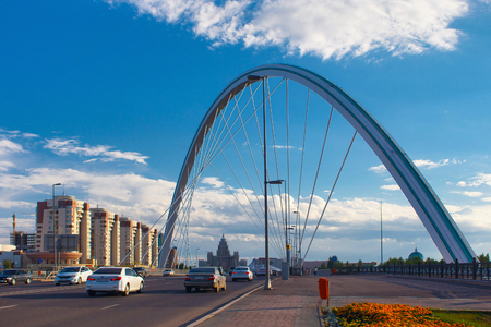 ASTANA, KAZAKHSTAN - JULY 25, 2017: Cityscape with road and modern bridge over the Ishim River in the center of Astana city. Astana is the capital city of Kazakhstan and the second-largest city.のeditorial素材