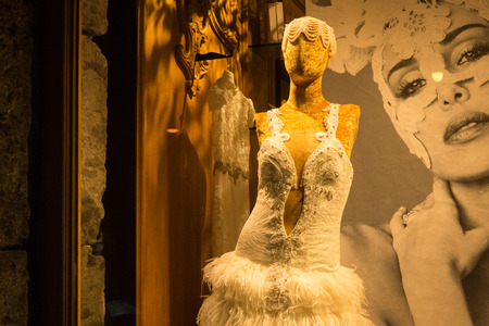 NAPLES, ITALY - OCTOBER 31, 2015: Mannequin dressed in a white dress in the window of one of the shops in the center of Naples at night.のeditorial素材