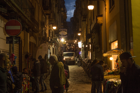 NAPLES, ITALY - OCTOBER 31, 2015: Unknown people on the one of the old shabby narrow streets in the historical part of Naples at night.のeditorial素材