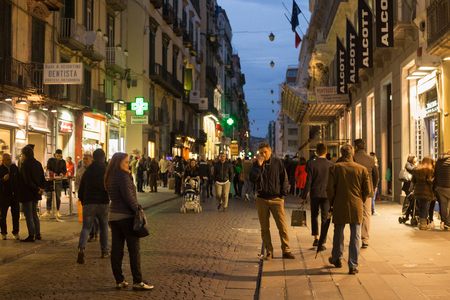 NAPLES, ITALY - OCTOBER 31, 2015: Walking tourists in the one of the central streets in the historical part of Naples at evening time.のeditorial素材