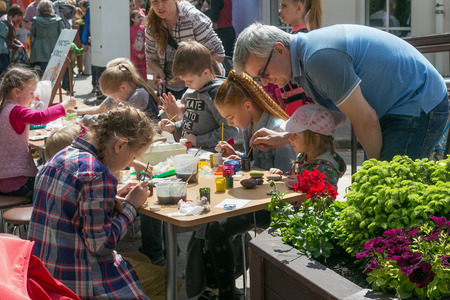 KALININGRAD, RUSSIA - MAY 21, 2016: Unknown children studying drawing on stones at a street workshop in Kaliningrad.のeditorial素材