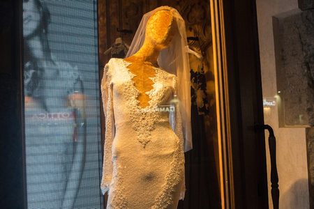 NAPLES, ITALY - OCTOBER 31, 2015: Mannequin dressed in a white dress in the window of one of the shops in the center of Naples at night.のeditorial素材