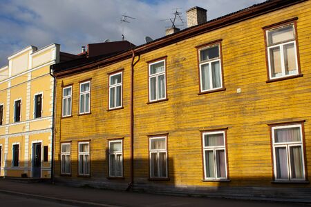 Old wooden shabby yellow building in historical center of Parnuの写真素材