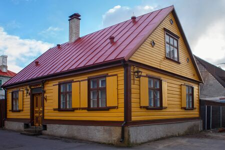 Old wooden yellow building with freshly painted walls in historical center of Parnu, Estonia.の写真素材