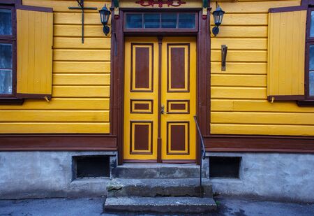 Doors in the old wooden yellow building with freshly painted walls in historical center of Parnu, Estonia.の写真素材